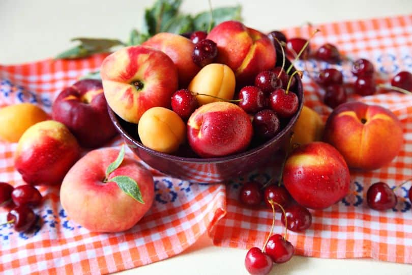 Bowl of cherries, peaches, and other fruits.