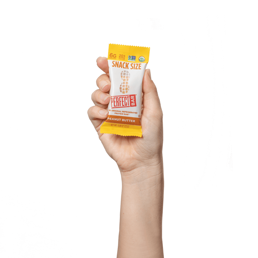 Hand holding Peanut Butter snack size bar 
